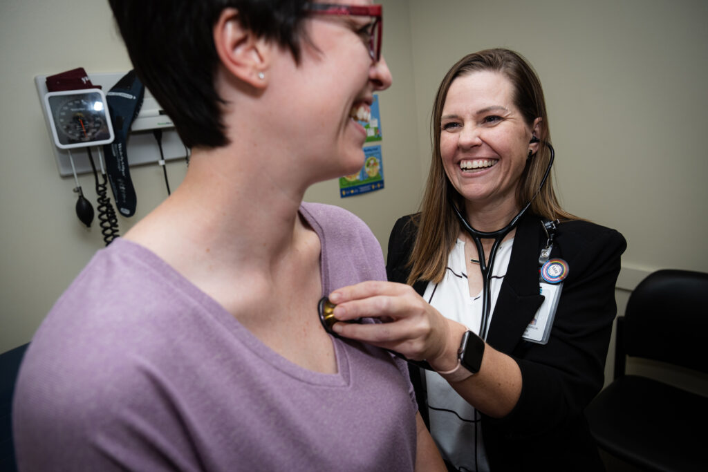 Nurse checking heart of patient