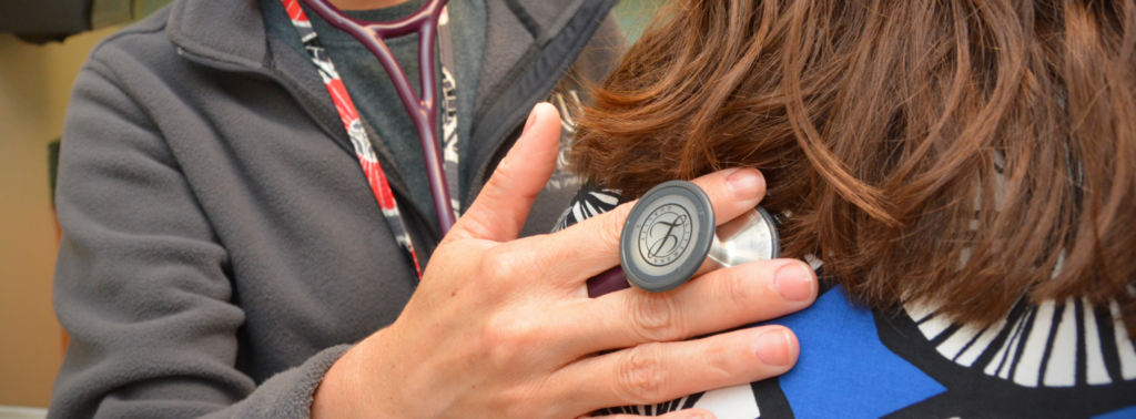 Doctor listening to patients lungs