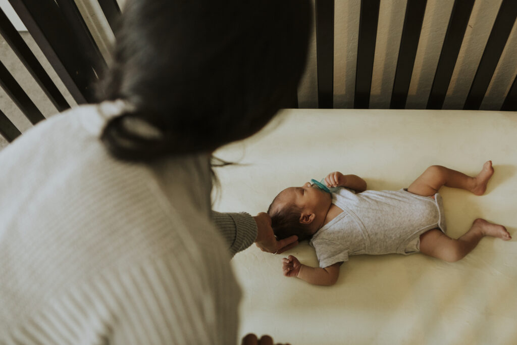 Mother looking at a sleeping baby