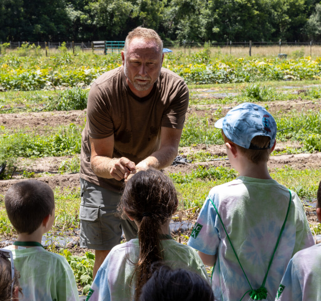 farmer presenting to young children