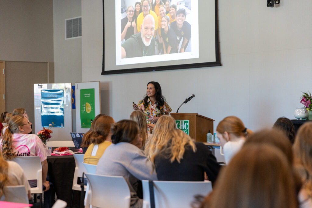 woman speaking to group of high school girls